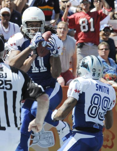 Pro Bowl MVP Larry Fitzgerald of the Arizona Cardinals collects one of his two TD receptions.  (Associated Press / The Spokesman-Review)