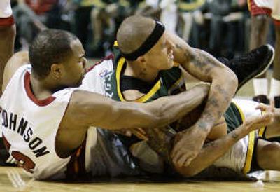 
Seattle's Delonte West, right, struggles for control of the ball Wednesday against Miami's Alexander Johnson. Associated Press
 (Associated Press / The Spokesman-Review)