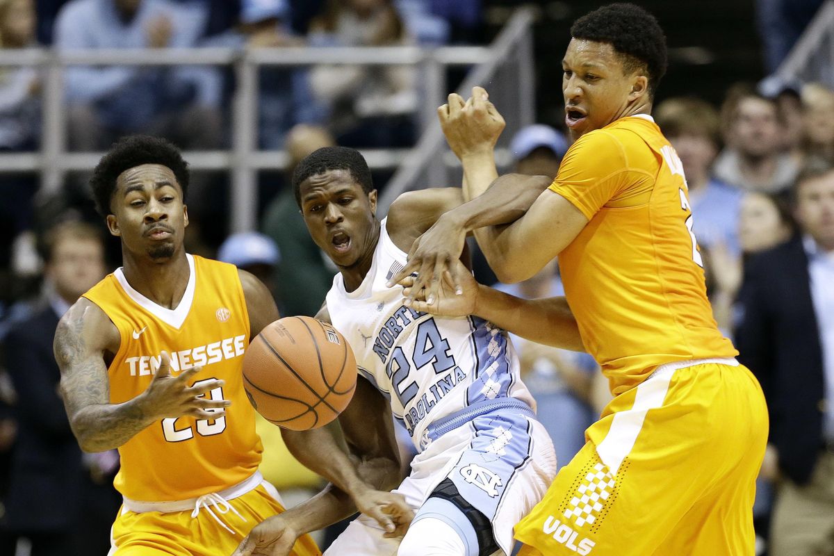 North Carolina’s Kenny Williams (24) struggles for possession of the ball with Tennessee’s Jordan Bowden and Grant Williams, right, during an NCAA college basketball game in Chapel Hill, N.C., Sunday, Dec. 11, 2016. The Vols lost to No. 7 UNC 73-71. (Gerry Broome / Associated Press)