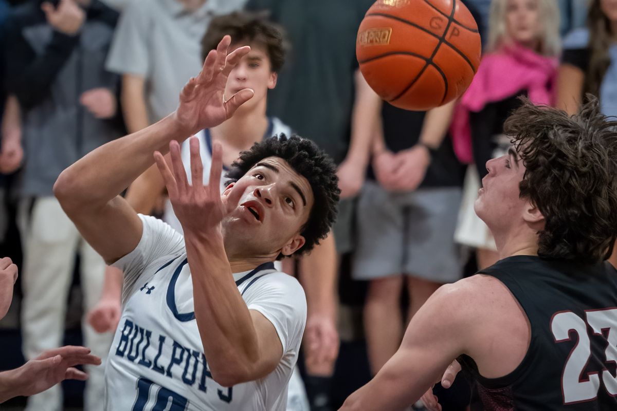 Gonzaga Prep guard Jamil Miller loses control of a rebound as Mt. Spokane forward Andrew Rayment (23) eyes the ball during a GSL high school basketball game, Friday, Jan. 13, 2023, at Gonzaga Prep.  (Colin Mulvany/The Spokesman-Review)