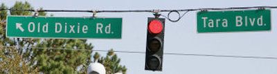 
A suburban Atlanta traffic signal is flanked by signs for Tara Boulevard and Old Dixie Road at an intersection in Jonesboro, Ga. 
 (Associated Press / The Spokesman-Review)