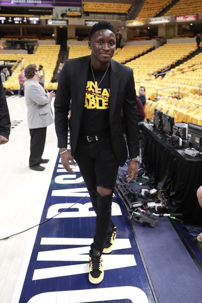 Injured Indiana Pacers guard Victor Oladipo (4) walks down the sideline during warmups before Game 4 of an NBA basketball first-round playoff series against the Boston Celtics in Indianapolis, Sunday, April 21, 2019. (Michael Conroy / Associated Press)