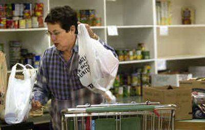 
Kathy Foreman weighs a donation at the Valley Food Bank in the Spokane Valley on Monday. With  eleven turkeys on hand and Thanksgiving around the corner, the agency needs donations. 
 (Liz Kishimoto/The Spokesman-Reivew / The Spokesman-Review)