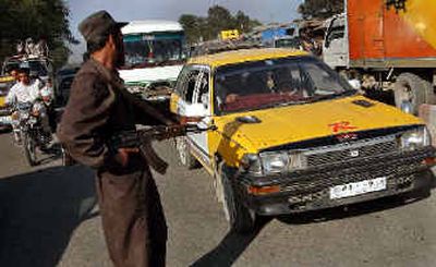
An Afghan security officer checks vehicles in Kabul, Afghanistan, on Saturday as the search continues for Italian Clementina Cantoni. The kidnapping of the CARE relief worker last week is the latest attack targeting foreigners in Kabul. 
 (Associated Press / The Spokesman-Review)