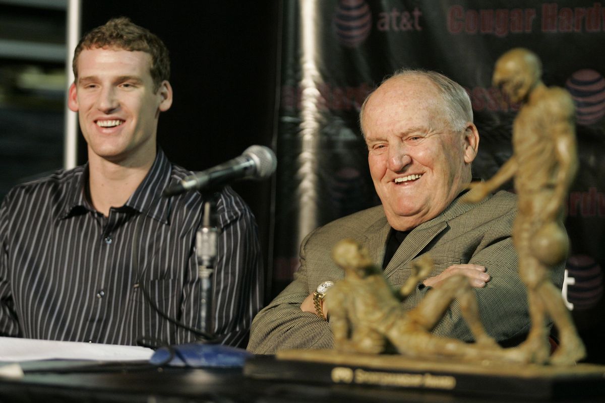 Washington State football quarterback Alex Brink, left, smiles as former Brigham Young football coach LaVell Edwards, right, talks about the Awards & Recognition Association Sportsmanship Award, displayed at right, which was given to Brink for his sportsmanship both on and off the field. The ceremony took place on Dec. 20, 2007, in Seattle. On Thursday, Edwards died at the age of 86. (Ted S. Warren / AP)