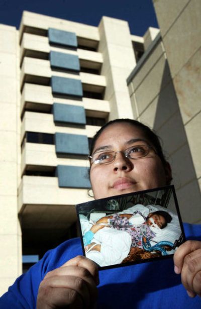 
Catarina Gonzales holds a photo of Emilio, her now-17-month-old son, in his hospital bed March 4,  in Austin, Texas. 
 (File Associated Press / The Spokesman-Review)