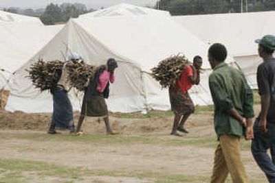 Women carry firewood at an