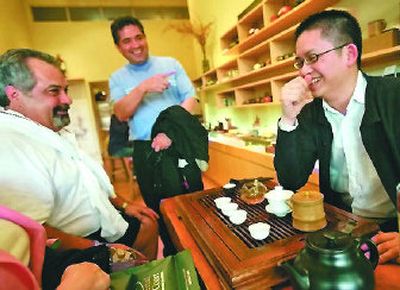 
Peter Luong, right, chats with customers at Red Blossom Tea Co., the family shop he's helped transform in San Francisco's Chinatown. 
 (Los Angeles Times / The Spokesman-Review)