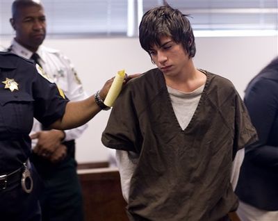 Jared Cano, 17, center, is led out of the courtroom in Tampa, Fla., Wednesday, Aug. 17, 2011after being charged with possession of bomb-making materials in connection with a plot for an attack at Freedom High School on the first day of school. He was arrested Tuesday night, after a confidential informant told Tampa police the teen was planning to blow up Freedom High School on the first day of class. Cano, an expelled student, faces felony charges of possessing bomb-making materials, cultivating marijuana, possession of drug paraphernalia, possessing of marijuana and threatening to throw, project, place or discharge a destructive device. ( (AP Photo/St. Petersburg Times, Cherie Diez))