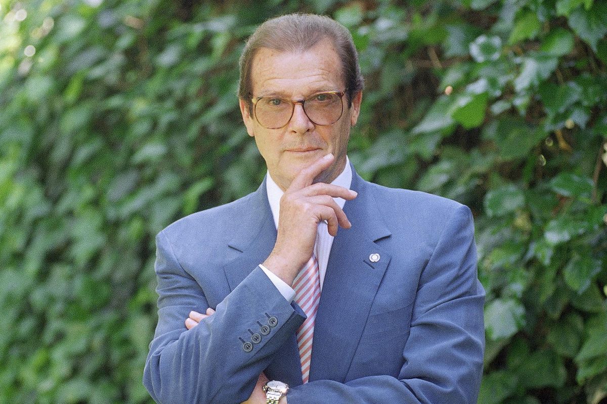 FILE - This is a April 22, 1996 file photo of veteran British actor Roger Moore, poses for a portrait, in the Studio City section of Los Angeles. Roger Moore