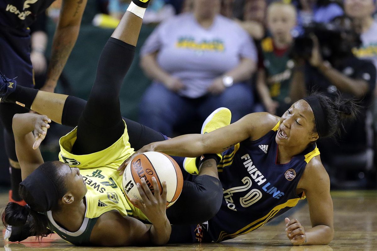 Seattle Storm’s Jewell Loyd, left, and Indiana Fever’s Briann January (20) fight for the ball in the first half of a WNBA basketball game Sunday, May 14, 2017, in Seattle. (Elaine Thompson / Associated Press)