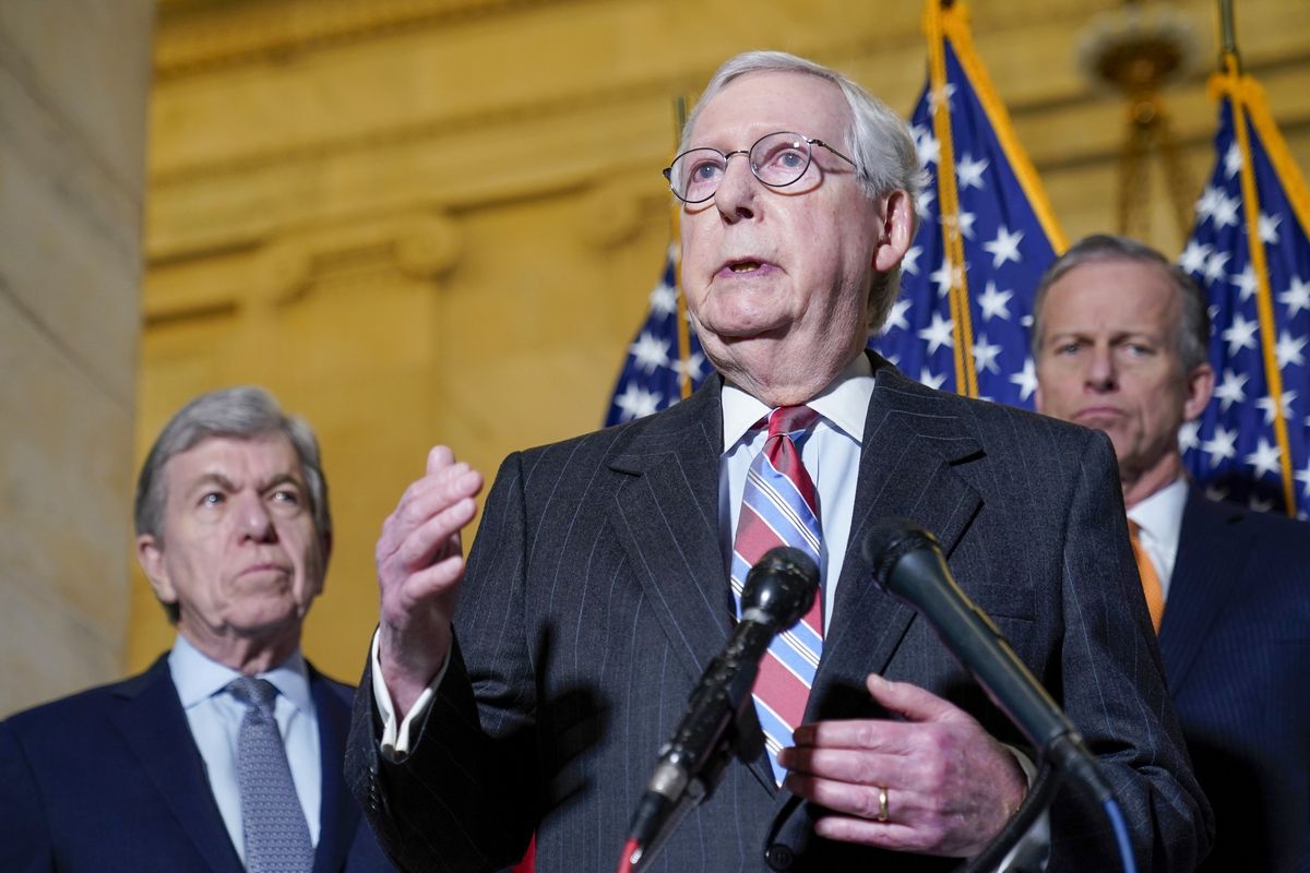 Senate Minority Leader Mitch McConnell of Ky., center, speaks to reporters on Capitol Hill in Washington, Tuesday, Feb. 8, 2022. Standing with McConnell is Sen. Roy Blunt, R-Mo., left, and Sen. John Thune, R-S.D., right. (Susan Walsh)