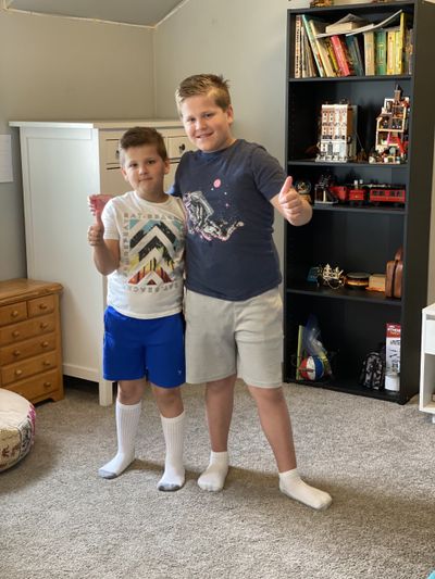 Hyrum and Emmett Ditto proudly display their newly clean bedroom.  (Julia Ditto)