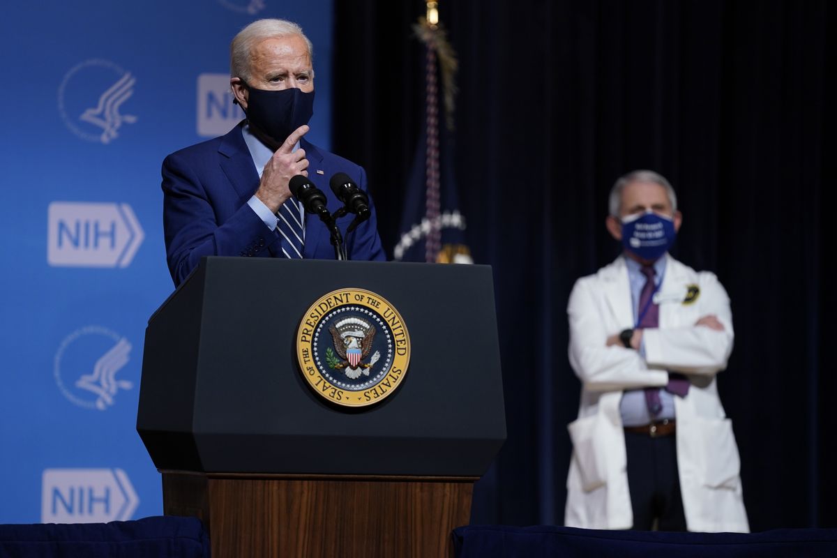 President Joe Biden speaks during a visit to the Viral Pathogenesis Laboratory at the National Institutes of Health, Thursday, Feb. 11, 2021, in Bethesda, Md. Dr. Anthony Fauci, director of the National Institute of Allergy and Infectious Diseases, listens at right.  (Evan Vucci)