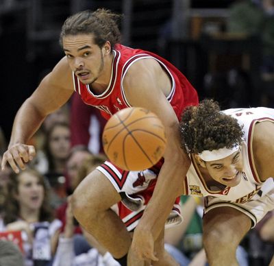 Chicago’s Joakim Noah, left, and Cleveland’s Anderson Varejao battle for a loose ball in the first quarter Thursday.  (Associated Press / The Spokesman-Review)