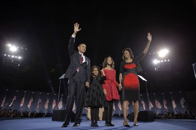 President-elect Barack Obama, his wife, Michelle Obama,  and their daughters, Sasha, 7, and Malia, 10, greet the crowd at an Election Night rally in Chicago.   (File Associated Press / The Spokesman-Review)