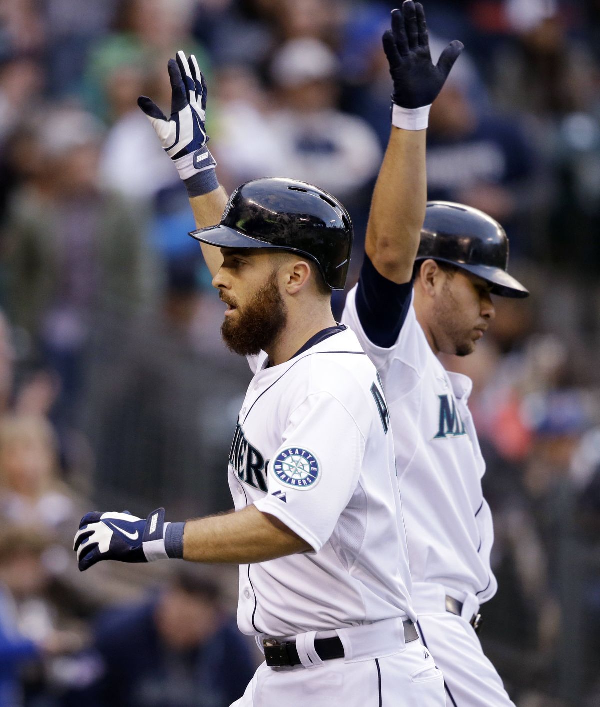Seattle’s Dustin Ackley, left, hit a home run. (Associated Press)