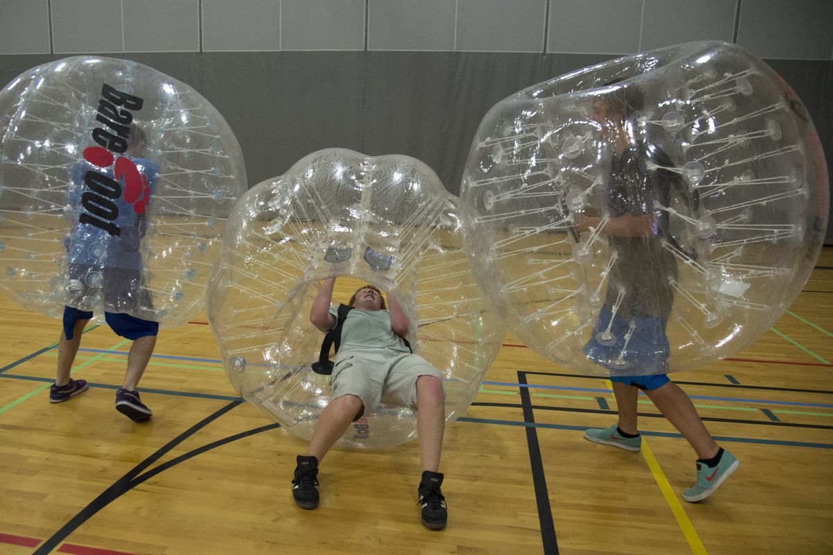 From left, Brad McCoy, Tyler Sparks and Russell Rubertt bounce off each other during a friendly game of bubble ball soccer at the HUB Sports Center in Liberty Lake on Sunday. (Colin Mulvany)