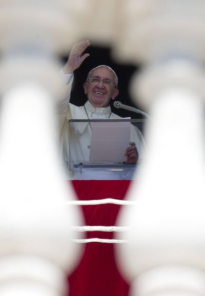 Pope Francis delivers his blessing Sunday from the window of his studio overlooking St. Peter’s Square at the Vatican. (Associated Press)