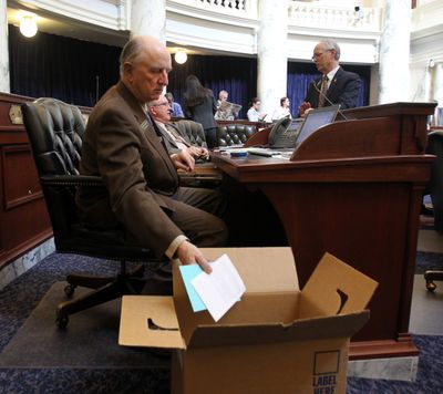 Idaho Rep. Steve Miller, R-Fairfield, packs up his desk on the floor of the House of Representatives on Thursday. (Associated Press)
