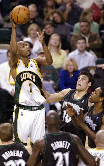 SuperSonics forward Rashard Lewis (7) goes for a shot over four Timberwolves. 
 (Associated Press / The Spokesman-Review)
