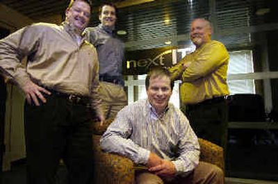 CEO Fred Brown (seated) with his team of executives at Next IT on Monday at the company offices in downtown Spokane. From left are Jim Hereford, Jeff Brown and Roger Keune.
(Christopher Anderson/ / The Spokesman-Review)