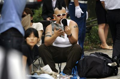 An eager customer sits in a camping chair in line outside Japanese mobile carrier Softbank’s flagship store in Tokyo’s Omotesando shopping district Wednesday before the first sales of Apple’s iPhone in Japan today. (Associated Press / The Spokesman-Review)