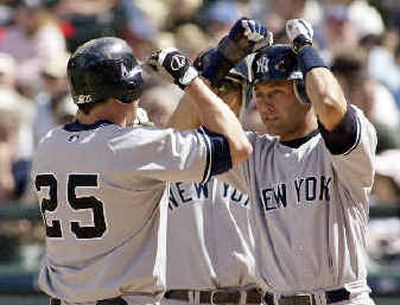 
Jason Giambi (25) is congratulated by Derek Jeter. Jason Giambi (25) is congratulated by Derek Jeter. 
 (Associated PressAssociated Press / The Spokesman-Review)