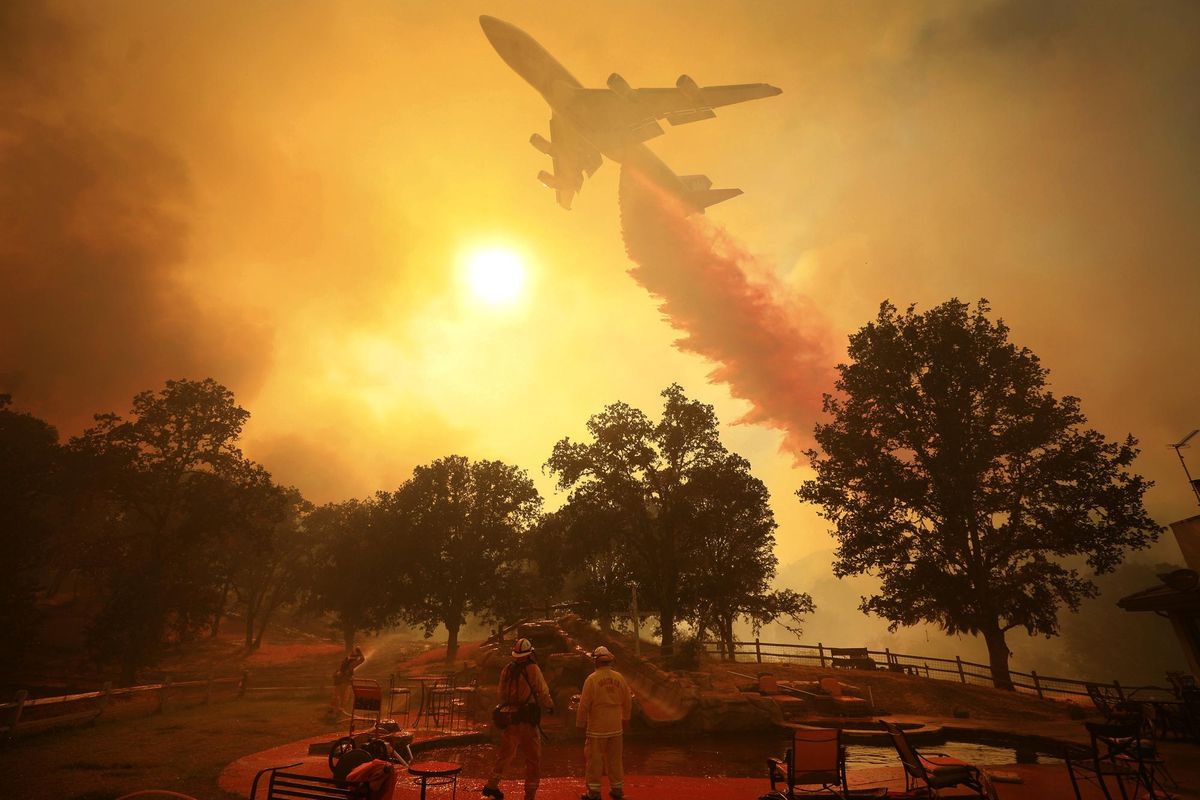 A 747 Global Airtanker makes a drop in front of advancing flames from a wildfire Thursday, Aug. 2, 2018, in Lakeport, Calif. (Kent Porter/The Press Democrat / Associated Press)