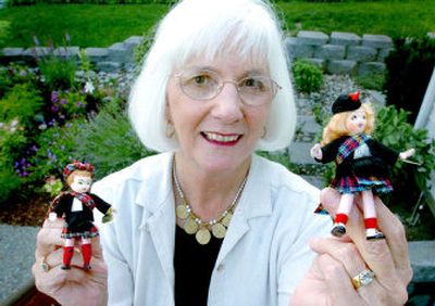 
Joy Reis shows off two of her Tiny Town Dolls. 
 (The Spokesman-Review)