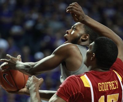Kansas State guard Jacob Pullen drives to the basket past Iowa State forward Calvin Godfrey on Saturday. (Associated Press)