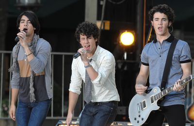 From left, musicians Joe Jonas, Nick Jonas and Kevin Jonas of the music group The Jonas Brothers perform in Bryant Park for ABC’s “Good Morning America”  on Aug. 8 in New York.  (Associated Press / The Spokesman-Review)