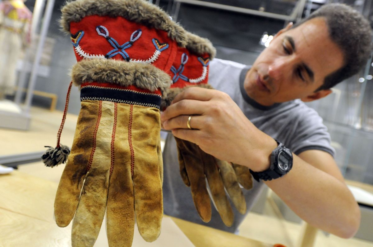 Collections specialist Chris Casserino mounts a pair of beaded gauntlets on a stand at the Northwest Museum of Arts and Culture. It’s part of the exhibit, “Living Legacy: The American Indian Collection,” that will be on display until July 2010. The exhibit is the first long-term Native American display since 2001. (Jesse Tinsley / The Spokesman-Review)