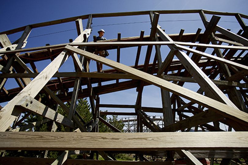 A Silverwood Theme Park maintenance worker checks the tracks of the Timber Terror wooden roller coaster Thursday in preparation for the park's opening weekend. (Jerome Pollos/press)
