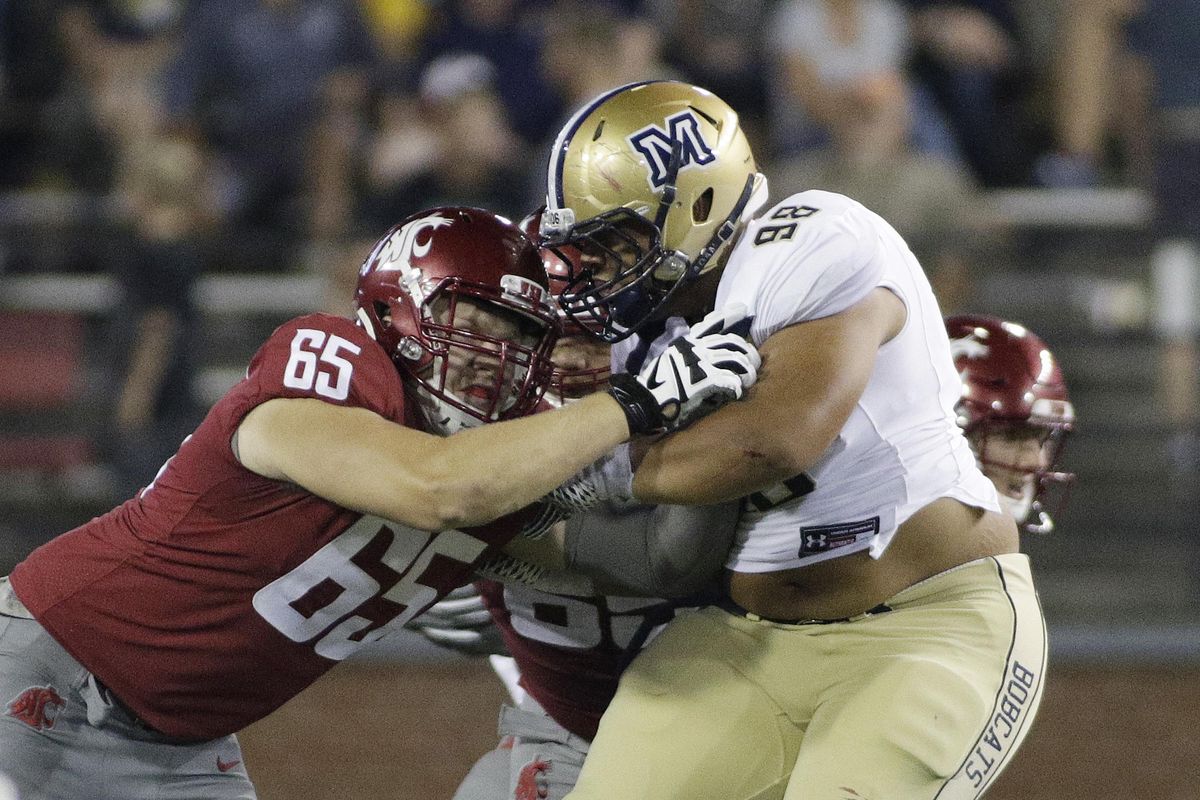 Washington State offensive lineman Josh Watson (65) blocks Montana State defensive lineman Marcus Ferriter (98) during the second half of a game in Pullman on Sept. 2, 2017. (Young Kwak / AP)