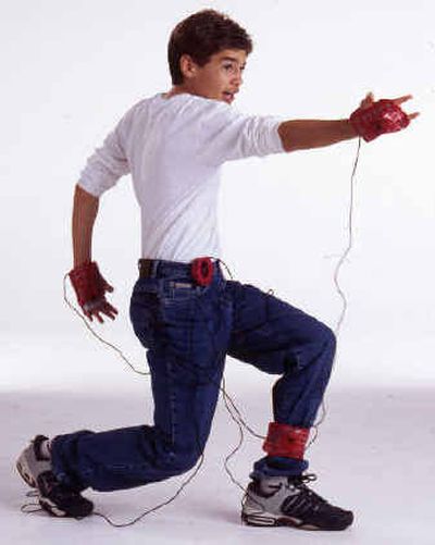 
An undated photo provided by Toy Quest shows a boy playing its Spiderman video game. Spider-Man 2 Web Action Video Gaming System has Spider-Man mirroring the player's movements on the TV screen using sensors strapped on the player's wrists and ankle. 
 (Associated Press / The Spokesman-Review)
