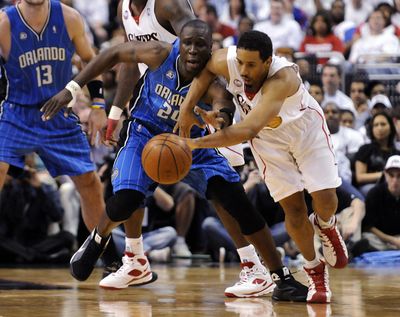 Orlando’s Mickael Pietrus and Philadelphia’s Andre Miller, right, scramble for a loose ball during the first half Friday night.  (Associated Press / The Spokesman-Review)