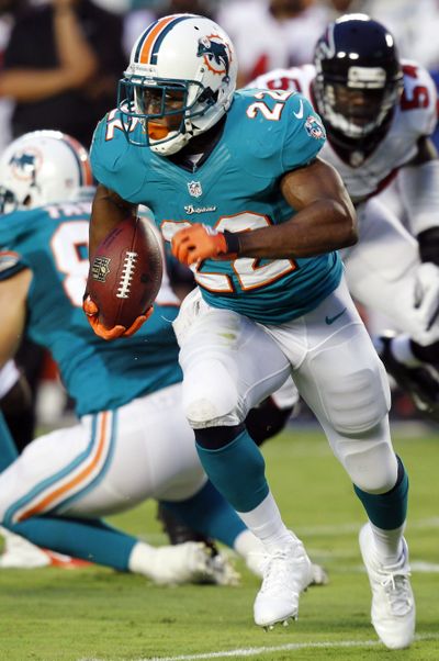 Reggie Bush’s goal is to lead the league in rushing for Miami. (Associated Press)