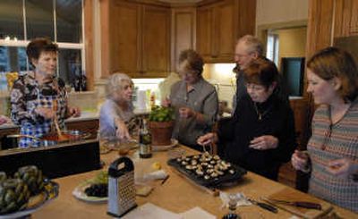 
After Clay Ruud retired from Penn State University, he wanted to return to his native Spokane and ski. So he designed a house in Northwoods and built a custom kitchen so his wife Paula Mannino, second from left, could offer cooking classes. She helped Joan Jans, left, Eunice Hubble, center, Karen Winterowd and Matena Peterson prepare a three-course Italian dinner last week. 
 (Photos by J. Bart Rayniak / The Spokesman-Review)