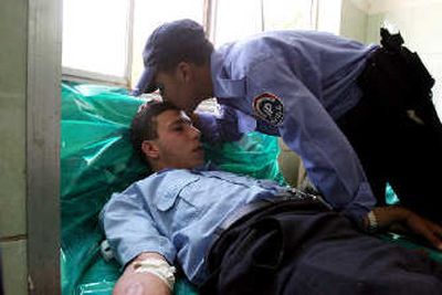 
An unidentified colleague kisses the forehead of Aussain Ali, an Iraqi policeman who was wounded in clashes between Iraqi police and gunmen in west Baghdad on Wednesday after gunmen attacked a police car. One police officer was killed and six others were injured.
 (Associated Press / The Spokesman-Review)