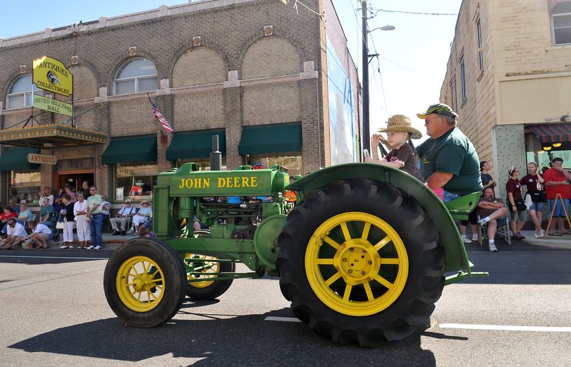 Greg Thomas, of Chattaroy, drives his 1937 John Deere tractor down Market Street in Hillyard with his granddaughter Lainee Shell, 5, in the Hillyard Hi-Jinks Parade on Saturday. The annual Hillyard Festival is celebrating its 100th incarnation. (Jesse Tinsley)