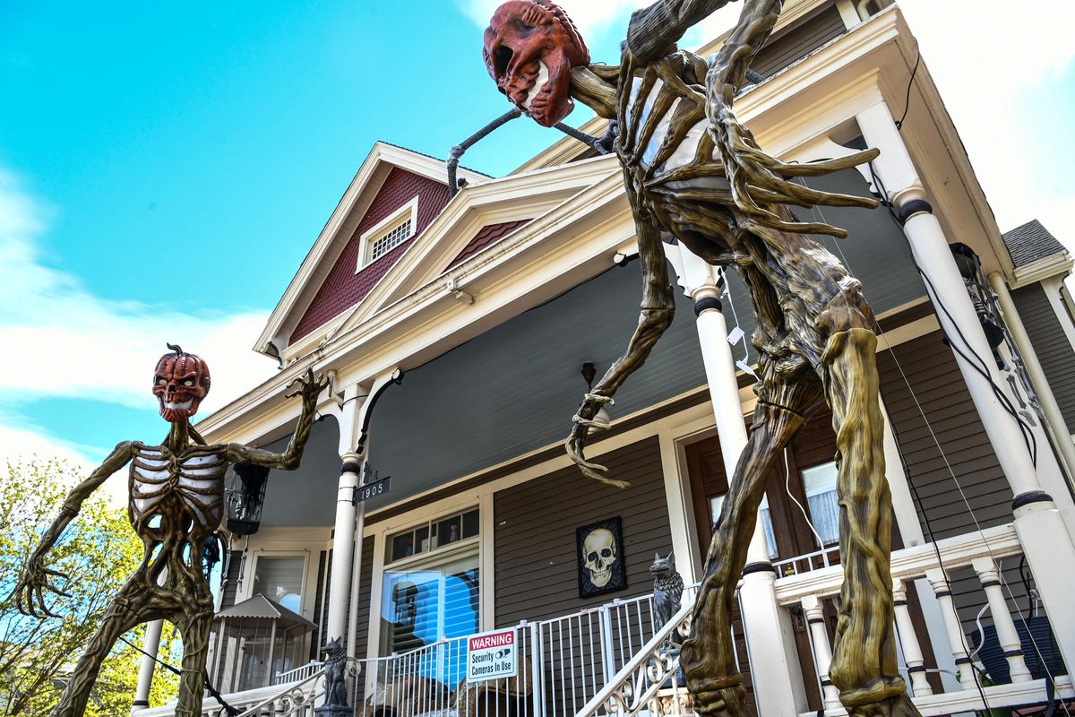 Giant Halloween skeletons dominate the front yard home at the corner of Pacific Avenue and Elm Street in Spokane’s Browne’s Addition.  (DAN PELLE/THE SPOKESMAN-REVIEW)