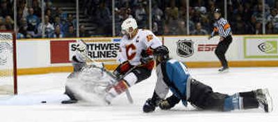 Calgary's Jarome Iginla (12) slips the puck past San Jose goalie Evgeni Nabokov as defenseman Brad Stuart looks on.
(Associated Press / The Spokesman-Review)
