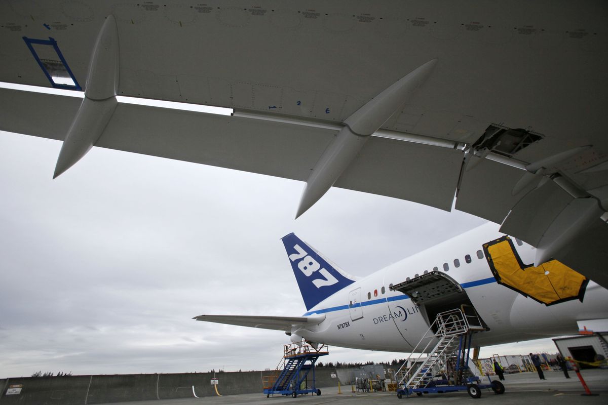 A wing of a Boeing 787 curves up and overhead on a plane used for testing at the production plant in Everett, Wash., Wednesday, Feb. 3, 2010.  (Elaine Thompson / Associated Press)