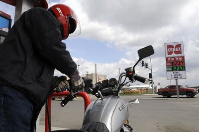 Jim Shaver, of Spokane Valley, fuels his motorcycle at the corner of Trent Avenue and Vista Road on Thursday.  Shaver says he gets 50 miles to the gallon.  (Dan Pelle / The Spokesman-Review)