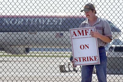 
Randy Kaiser, an airline mechanic and a member of the Mechanics Fraternal Association (AMFA), pickets against Northwest Airlines Corp. on Sunday outside the Minneapolis-St. Paul International Airport in Bloomington, Minn. 
 (Associated Press / The Spokesman-Review)
