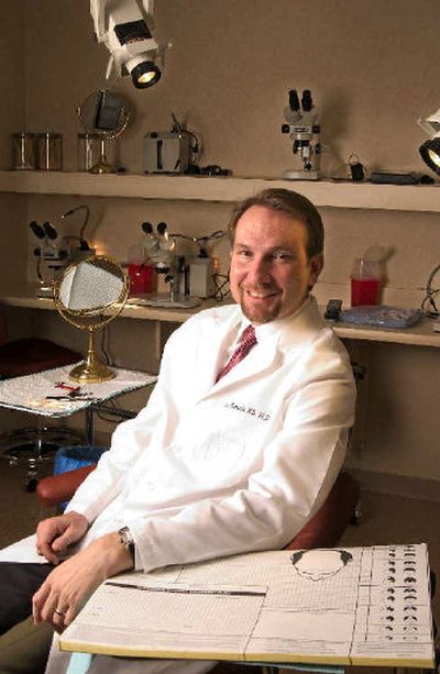 
Dr. Ken Washenik with a baldness chart, right foreground. Washenik is part of the Aderans Research Institute in Philadelphia which is investigating the 