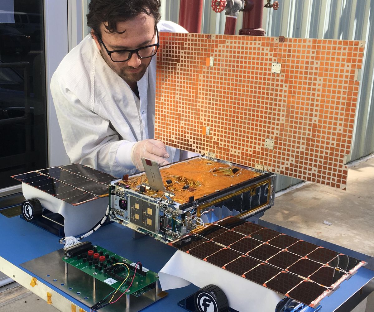 In this undated photo made available by NASA in March 2018, engineer Joel Steinkraus uses sunlight to test the solar arrays on one of the Mars Cube One project (MarCO) spacecraft at NASA’s Jet Propulsion Laboratory in Pasadena, Calif. WALL-E and EVE, a pair of tiny experimental satellites, hitched a ride on the same rocket that launched InSight to Mars in May. This MarCO built and managed by NASA’s Jet Propulsion Laboratory, cost $18.5 million. (AP)