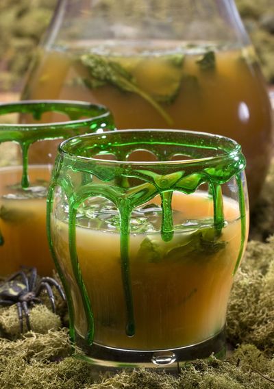 Halloween swamp sangria, complete with green “slime” oozing down the glass, is far more delicious than your eyes may be telling you it is. (Associated Press)