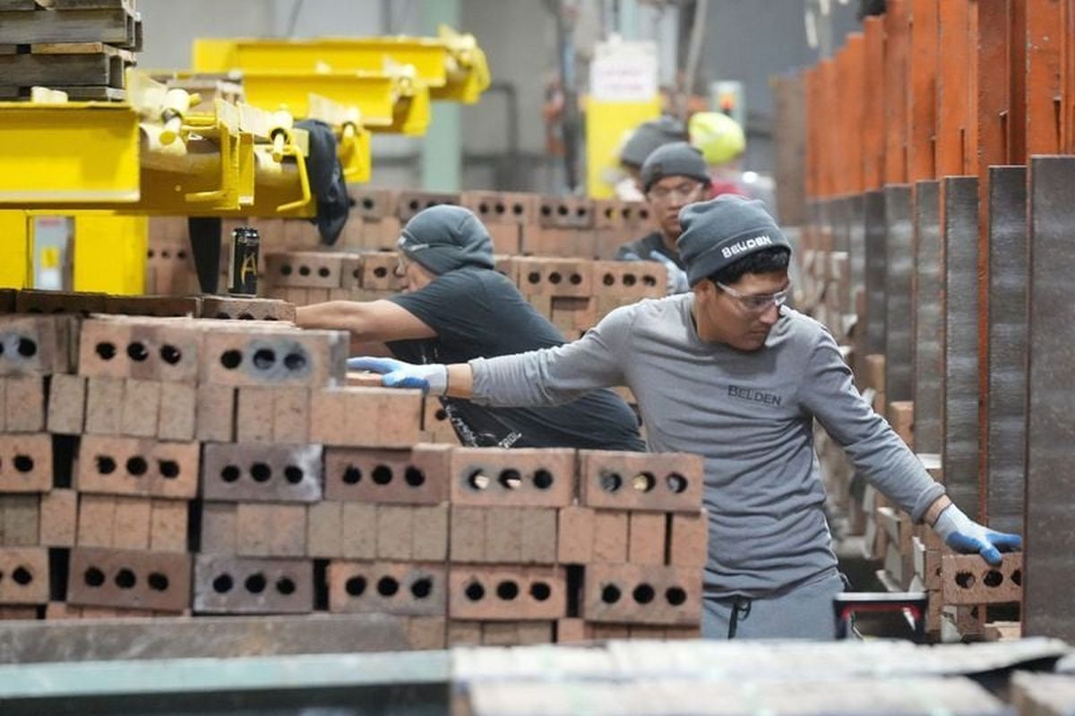 Workers package and cube pallet bricks for shipping last November at Belden Brick in Sugarcreek, Ohio.  (Kevin Whitlock/Massillon Independent/USA TODAY NETWORK )